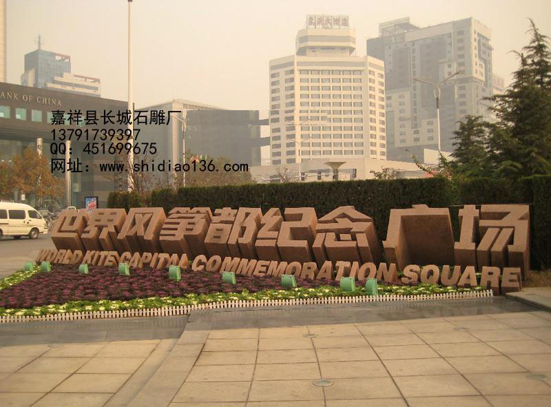 下面的标志是，旅游区标志，雕刻的是世界风筝都纪念广场。